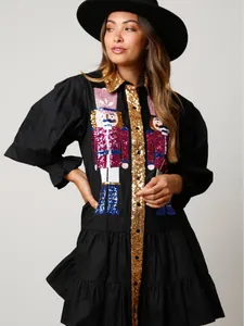Elegant black long sleeve Christmas dress with sequined Nutcracker embroidery details.