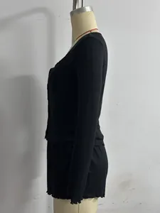 Side view of a black ribbed knit long-sleeve top and lettuce hem shorts lounge set
