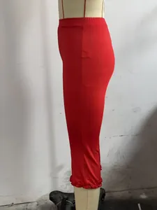 Detailed side view of solid red calf-length casual pants featuring elegant ruffled hemline