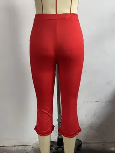 Back view detail showing the ruffled hem of red casual capri pants on a mannequin
