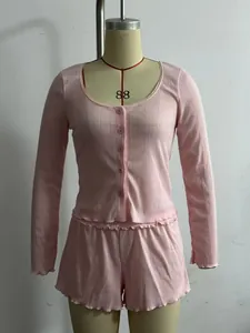 Detail of pink long-sleeve top and lettuce hem shorts set displayed on a mannequin