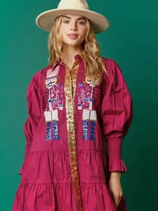 Elegant fuchsia long sleeve dress featuring nutcracker sequin embroidery and tiered skirt