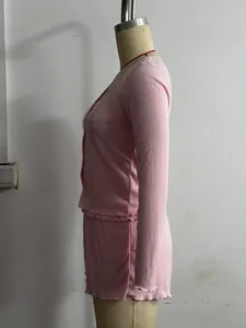 Side view profile of a pink French style casual knit set with ruffle trims on mannequin
