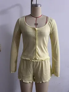 Pale yellow long-sleeved top and shorts set with lettuce-edge trim on mannequin