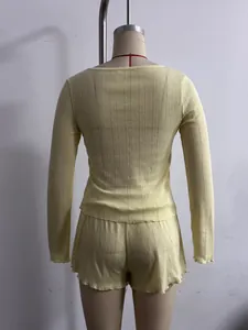 Detail back view of a yellow knitted two-piece lounge set with lettuce edge trim.