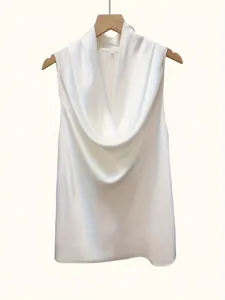 Detailed view of elegant white satin sleeveless top featuring a chic cowl neck draping