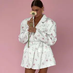 Chic white floral blazer featuring a notched lapel and tie-waist for a sweet spring look