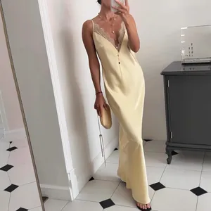Vue détaillée d'une robe nuisette en satin champagne avec bordure en dentelle au décolleté.