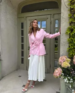 Elegant pink blazer with large 3D flower waist tie and white pleated midi skirt