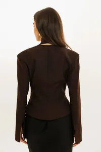 Back view of a stylish brown slim-fit cropped blazer with a unique halter neck detail