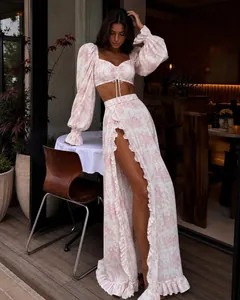 Elegant pink floral crop top and high-slit maxi skirt set for a chic summer look.