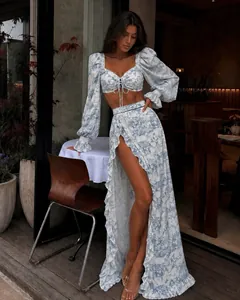 Full view of elegant blue and white floral crop top and ruffled high slit maxi skirt set