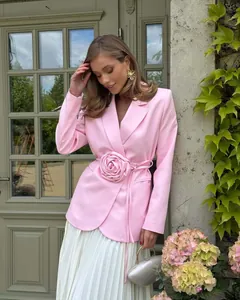 Elegant pink blazer with 3D fabric flower decoration and adjustable tie waist.