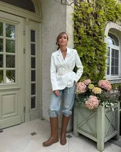 Outdoor fashion shoot of white blazer with 3D rose detail and tie waist design