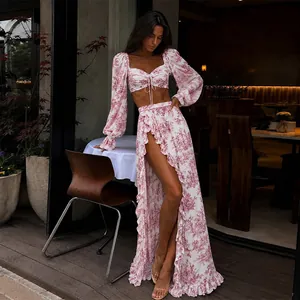 Model wearing floral two-piece set with tie-front crop top and ruffled high-slit maxi skirt