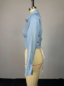 Side view of blue and white striped long-sleeved shirt with waist ties on a mannequin.