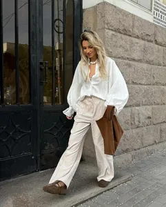 Detailed shot of white oversized long-sleeve shirt with chic balloon sleeves for spring.