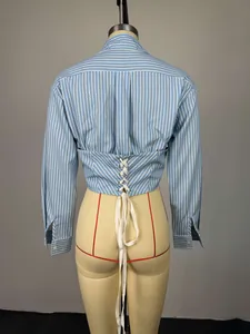 Detail of blue and white striped cropped shirt featuring an elegant lace-up back design