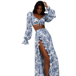 Bohemian floral print two-piece set featuring tie-front crop top and slit maxi skirt