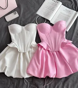 Detailed view of elegant pink and white corset tops with matching bubble mini skirt sets