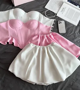 Stylish strapless corset top and bubble mini skirt set in pink and white detail.