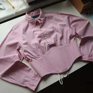 Detail view of pink and blue striped shirt featuring a unique corset waist design