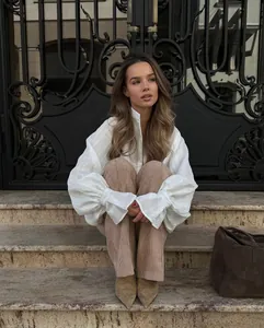 Detail of white oversized long-sleeve blouse with stylish lantern sleeves and texture