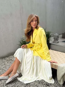 Stylish yellow blazer featuring 3D flower decoration and adjustable belted waist.