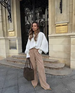 Elegant white oversized long sleeve blouse with a minimalist lapel design for spring.