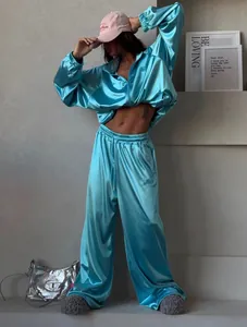 Fashionable turquoise satin tracksuit set featuring a cropped hoodie and wide-leg pants