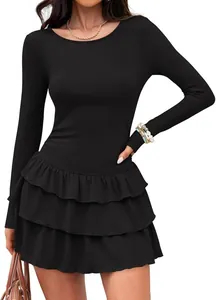 Close-up view of the elegant tiered ruffled skirt on a black long sleeve knit mini dress.