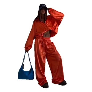 Vibrant orange satin oversized tracksuit set with zip jacket and wide-leg trousers