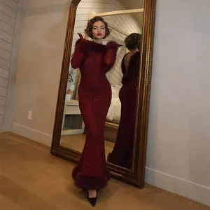 Elegant deep red backless mermaid dress featuring luxurious fur trim and sparkling rhinestones