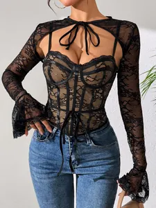 Detail shot of black lace shrug and mesh camisole set with intricate floral patterns