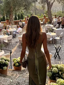 Elegant back view of a woman wearing an olive green lace-up corset and satin maxi skirt set