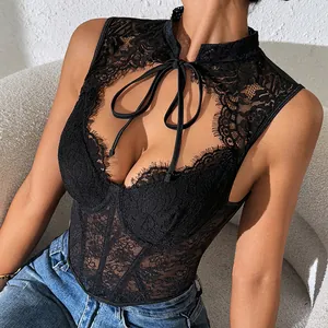 Detail shot of black lace boned corset top featuring intricate floral patterns.
