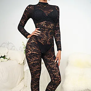 Elegant black lace long sleeve jumpsuit worn by a model in a bedroom setting