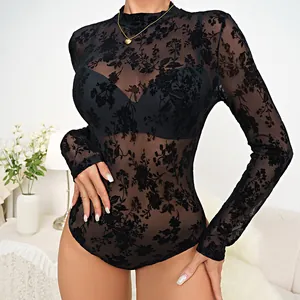 Detail view of black floral flocked mesh bodysuit showing sheer texture and long sleeves