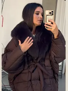 Detail view of dark brown quilted puffer jacket with large fur collar and tie waist.