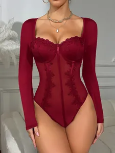 Close-up of elegant burgundy long-sleeved bodysuit with sheer lace and boning detail