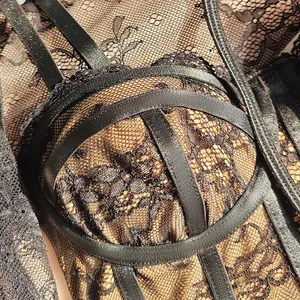 Detailed close-up of a sexy black lace mesh camisole featuring intricate strap designs
