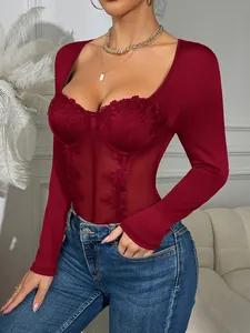 Close-up of wine red lace bodysuit with fishbone corset details and sheer mesh panels