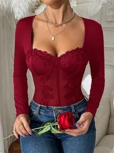 Detail view of sexy red long sleeve bodysuit with lace patchwork and corset boning.