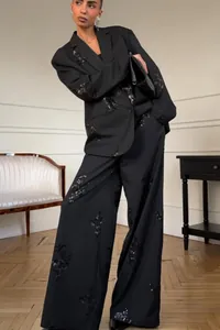 Elegant black two-piece suit set featuring sequin floral embroidery and wide-leg trousers