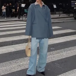 Oversized grey blue V-neck blazer coat with diagonal lapels shown in a street setting