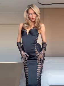 Close-up of black bodycon lace dress featuring side cut-outs and matching lace gloves.