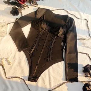 Intricate detail view of black lace corset bodysuit with long sleeves and mesh panels