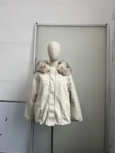 Dettaglio del cappotto invernale color crema con cappuccio e collo in pelliccia su manichino