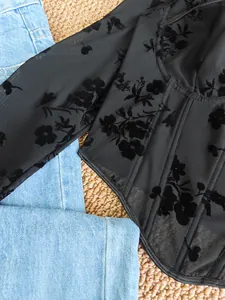 Detailed macro view of black mesh floral burnout corset top with boning structure