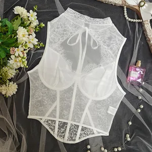 Detailed view of white lace corset top with underwire and mesh paneling details